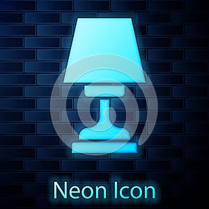 Glowing neon Table lamp icon isolated on brick wall background. Vector