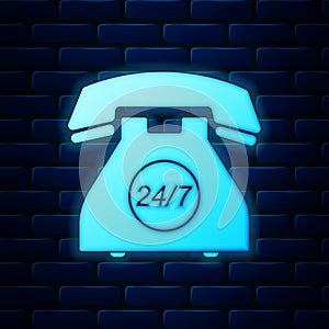 Glowing neon Telephone 24 hours support icon isolated on brick wall background. All-day customer support call-center