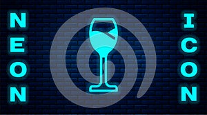 Glowing neon Wine glass icon isolated on brick wall background. Wineglass icon. Goblet symbol. Glassware sign. Happy