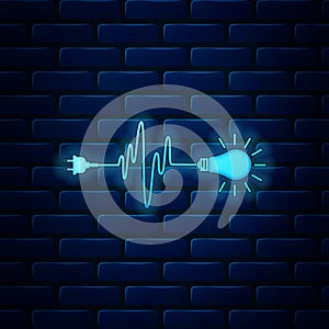 Glowing neon Wire plug and light bulb icon isolated on brick wall background. Plug, lamp and cord in the form of