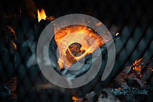 Glowing orange burning embers in a chiminea fire