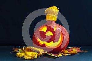 Glowing pumpkin with autumn leaves on a dark background. Jack`s Lantern. Halloween Decorations