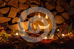 Glowing pumpkin for halloween night on firewood background