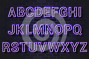 Glowing purple neon lamp alphabet on a black brick wall