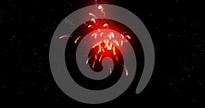 Glowing red firework exploding on black background with defocussed blue spots