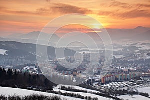 Glowing red sky over tower blocks of snowy Dolny Kubin Slovakia