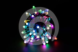 Glowing RGB led pixels christmas holiday lights on black background