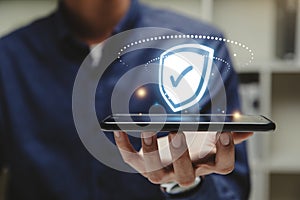 Glowing shield with a check mark on smart phone