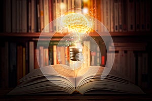 Glowing and shining brain lightbulb over an open book with a bookshelf as background. Knowledge, study, cognition, learning,