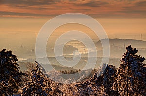 Glowing sunrise over Budapest and Danube in winter morning mist
