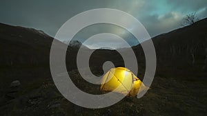 Glowing Tent and Clouds at Night in Khibiny Mountains. Russia. Time Lapse