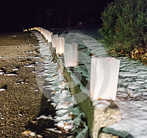 Glowing white bag luminaries light up the neighborhood