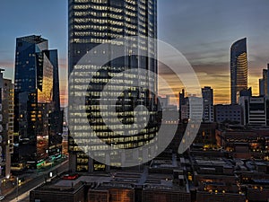 Glowing windows of skyscrapers skyline at sunset - View of modern offices and towers, Abu Dhabi, UAE