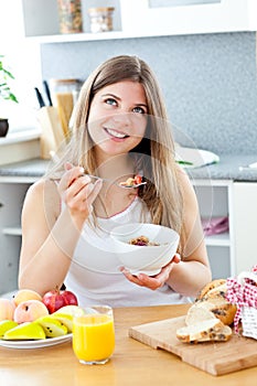 Glowing woman eating cereals with raspberries