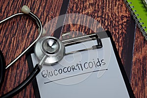 Glucocorticoids write on paperwork isolated on wooden table photo