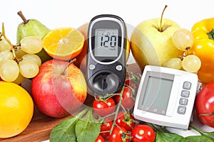 Glucometer, blood pressure monitor and fruits with vegetables, healthy lifestyle