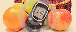 Glucometer for checking sugar level, fresh fruits and dumbbells using in fitness. Healthy nutrition and sporty lifestyles