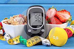 Glucometer for checking sugar level, healthy food, dumbbells and centimeter, diabetes, healthy and sporty lifestyle photo