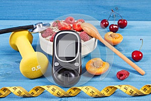 Glucometer for checking sugar level, oatmeal with fruits, tape measure and dumbbells, diabetes and healthy lifestyle