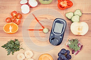 Glucometer with clock made of fruits and vegetables, healthy eating for diabetics concept