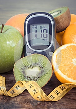 Glucometer, fresh fruits and orange juice. Healthy lifestyle and nutrition containing minerals and vitamins during diabetes
