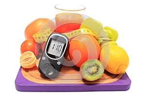 Glucometer, fruits, dumbbells, tape measure and glass of juice