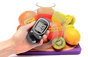 Glucometer, fruits, dumbbells, tape measure and glass of juice