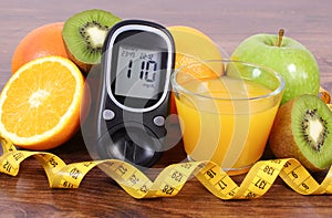 Glucometer, fruits, juice and tape measure, diabetes lifestyles and nutrition