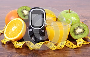 Glucometer, fruits, juice and tape measure, diabetes lifestyles and nutrition