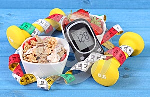 Glucometer with result sugar level, healthy food, dumbbells and centimeter, diabetes, healthy and sporty lifestyle concept