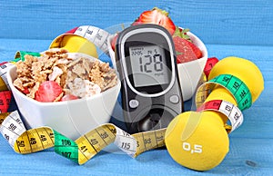 Glucometer with result sugar level, healthy food, dumbbells and centimeter, healthy and sporty lifestyle concept