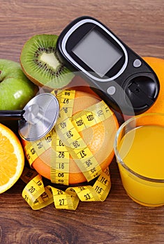 Glucometer, stethoscope, fruits, juice and centimeter, diabetes lifestyles and nutrition