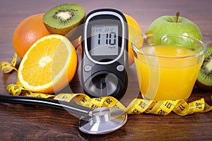 Glucometer, stethoscope, fruits, juice and centimeter, diabetes lifestyles and nutrition concept