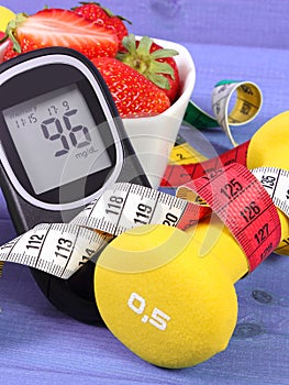 Glucometer with sugar level, fresh strawberries, dumbbells and centimeter, diabetes, healthy and sporty lifestyle