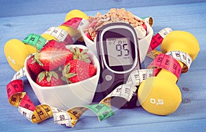 Glucometer with sugar level, healthy food, dumbbells and centimeter, diabetes, healthy and sporty lifestyle