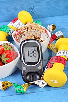 Glucometer with sugar level, healthy food, dumbbells and centimeter, diabetes, healthy and sporty lifestyle