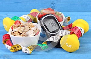 Glucometer with sugar level, healthy food, dumbbells and centimeter, diabetes, healthy and sporty lifestyle