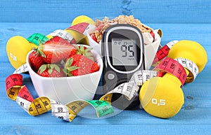 Glucometer with sugar level, healthy food, dumbbells and centimeter, diabetes, healthy and sporty lifestyle