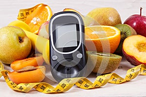 Glucometer, tape measure and fresh natural fruits containing vitamins for healthy lifestyles of diabetics