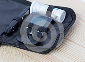 Glucometer and test strip lies in bag case