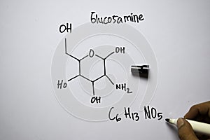 Glucosamine C6,H13,NO5 molecule written on the white board. Structural chemical formula. Education concept