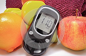 Glucose meter for checking sugar level, fresh fruits and dumbbells using in fitness. Healthy nutrition and sporty lifestyles
