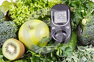 Glucose meter with fruits, vegetables and sprouts. Checking sugar level and healthy lifestyles