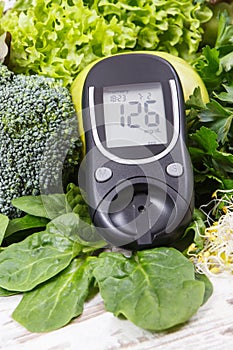 Glucose meter with fruits, vegetables and sprouts. Checking sugar level and healthy lifestyles