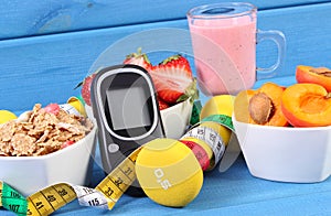 Glucose meter, healthy food, dumbbells and centimeter, diabetes, healthy and sporty lifestyle concept