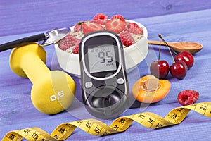 Glucose meter, oat flakes with fruits, dumbbells and tape measure, concept of diabetes, slimming and sporty lifestyle