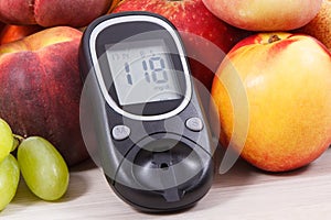 Glucose meter with result sugar level and fruits containing vitamins for healthy lifestyles of diabetics