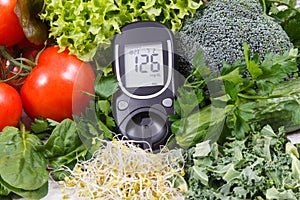 Glucose meter with vegetables and sprouts. Checking sugar level and healthy lifestyles