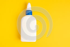 Glue plastic white bottle on a yellow background