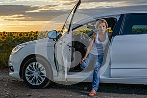 Glum woman sitting waiting for roadside assistance